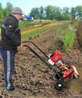 Man using 52CC Gas Powered Tiller Cultivator With 2 Stroke Engine in a farm field