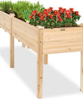 Front view of a Raised Wood Garden Bed With Elevated Planter Stand, 72 By 24 By 30 Inches, planted with herbs and flowers.