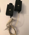 41A4373A Safety Sensors For Garage Door Openers that play nice with LiftMaster and Chamberlain units, black casing with wires shown