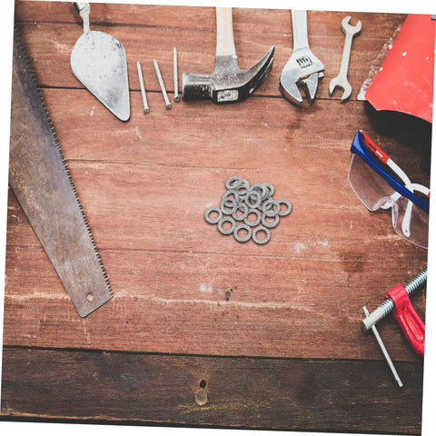 Premium 20 Piece Manganese Lock Washers With Double Wedge Tooth Design on a wooden workbench with tools around.