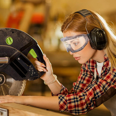 Woman wearing oversized safety goggles that fit over glasses for lab work, chemistry and DIY projects, anti fog, clear PC lens.