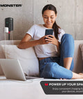 Woman using phone and laptop connected to Power Shield XL Surge Protector with Outlet Extender 4 Grounded AC Outlets and 2 USB A Ports.