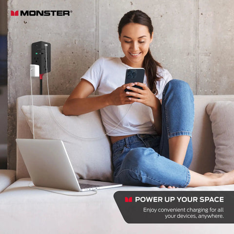 Woman using phone and laptop connected to Power Shield XL Surge Protector with Outlet Extender 4 Grounded AC Outlets and 2 USB A Ports.