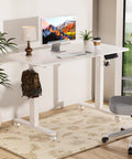 Electric Standing Desk With Adjustable Height And Memory Presets Heavy Duty Steel Base Rolling Casters For Office Gaming Home Setup 48X24 Inches White with monitor, lamp, and plants.
