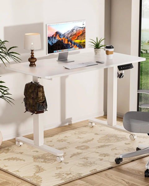 Electric Standing Desk With Adjustable Height And Memory Presets Heavy Duty Steel Base Rolling Casters For Office Gaming Home Setup 48X24 Inches White with monitor, lamp, and plants.