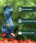 Outdoor Hand Blown Glass Hummingbird Feeder With 24 Oz Capacity And Four Feeding Ports, colorful glass hanging in a garden setting