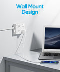 Super Sleek Flat Plug Power Strip With Ten Foot Extension Cord That Tames Cord Chaos And Fits Snug Behind Furniture Featuring Eight Wide Spaced Outlets And Four Fast Charge Ports Including Usb C For Stress Free Dorm Home Travel In White, wall mount design with laptop and phone.