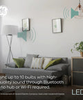 LED Plus Bluetooth Speaker Light Bulb Soft White A21 60W Equivalent Three Pack with remote in a modern living room setting