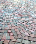Heavy Duty Water Based Paver And Concrete Sealer Shields Brick Stone Masonry Locks Joint Sand Boosts Raw Color UV Shield Waterproof Patio Armor Slick Crisp Finish Five Gallon applied to a circular brick pattern.