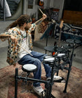 Musician playing DED-200X Electronic Drum Set with Quiet Mesh Pads and Realistic Feel in home studio setting