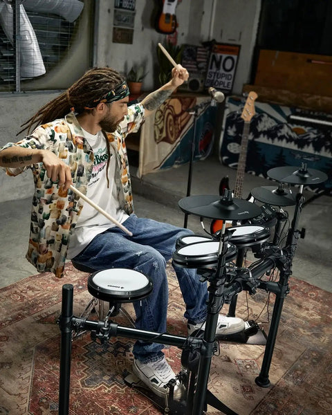 Musician playing DED-200X Electronic Drum Set with Quiet Mesh Pads and Realistic Feel in home studio setting