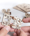 Self Assembly Tribiks Anti Stress Wooden Mechanical Models Kit For Adults And Kids Five And Up Four Miniature Models Desk Toy For Stress Relief Creative Wood Craft Set That Sparks Focus And Fun. close-up of beige wooden gear model in hands