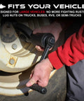 Man using Roadside Ready 1 Inch Drive Torque Multiplier Wrench for quick removal of rusted lug nuts on large vehicle tire.