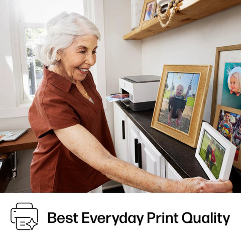 Woman placing photo on shelf with Refillable Ink Tank All-In-One Printer With Wireless, Scanner And Copier in the background