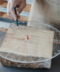 Person using Clear Acrylic Center Finder Gauge For Circles 11.8 Inch Diameter Lathe Centering Tool on wood block.
