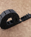 Two Pack Nylon Drag Cable Chains 18x37mm semi-closed wire carriers in curved arrangement on beige surface