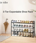 Expandable Three Tier Metal Shoe Rack Holds Up To Sixteen Pairs with shoes displayed in a hallway next to an umbrella.