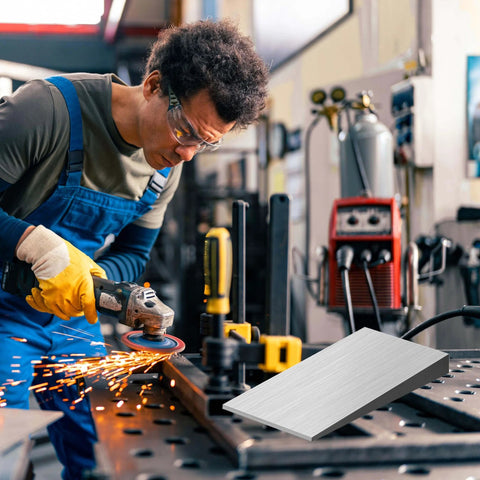 Four Piece Steel Flange Wedge Set 4 By 2 Inch Beveled Wedges in a workshop with lathe and welding equipment