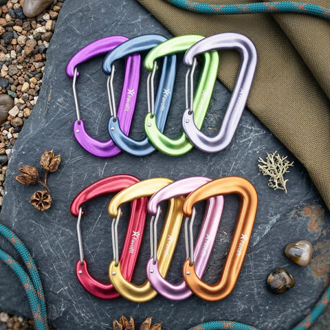 Colorful Built Tough Ultra Strong 12kN Carabiner Clips 3.2 Inch Aluminum Carbineers for hiking on slate background