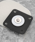 Front view of 1-inch pulse valve diaphragm plate with white diaphragm and center pin on black mounting plate