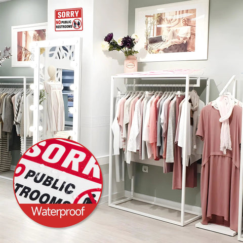 Clothing store interior with visible 'Sorry No Public Restrooms' sign; Two Pack No Public Restroom Signs For Biz And Home Self Adhesive Weatherproof Vinyl Stickers