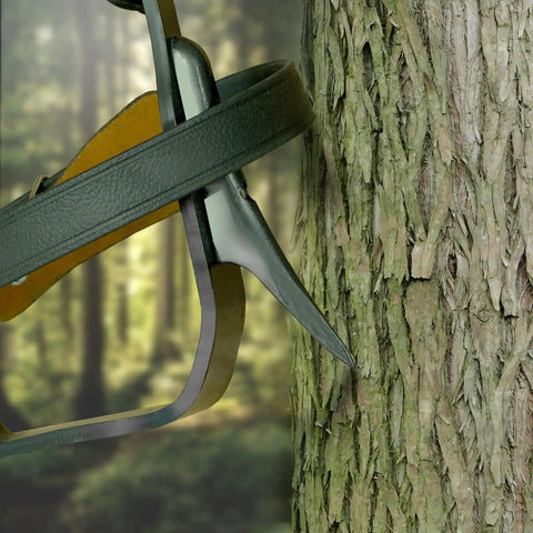 Built Tough Tree Climbing Spikes Set with Adjustable Straps and Spike Protectors, 350 lb Load Capacity in use on tree trunk.