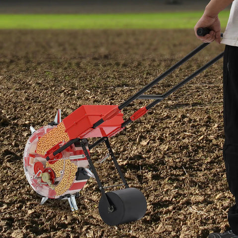 Person using Hands On Walk Behind Seeder For Garden Planter With Roller Spreader And 7 Nozzles on soil, durable iron and ABS construction