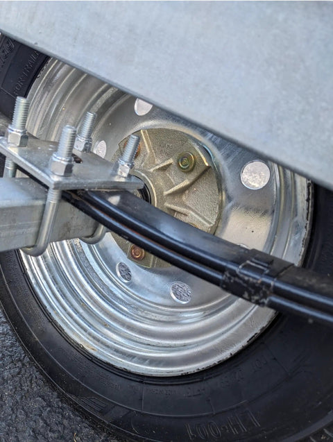 Oil Bath Hub Kit BT150A For One And One Sixteenth Inch Straight Spindle Boat Trailer Replacement Part, Five Lug With Four And One Half Inch Bolt Pattern, Pre Pressed Races Inner Bearing Oil Seal And Studs Included, Heavy Duty Ready To Install, Gold Finish on tire and wheel assembly.