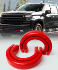 Red Front Tow Hook Covers For Chevy Silverado 1500 And GMC Sierra 1500 displayed in front of a truck