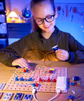 Circuit Explorer Boost Kit for Kids 8 and Up DIY Electronics Lab With 40 Piece Set Motor And LED Lights Cool Hands On STEAM Experiments For Curious Builders, girl building circuit