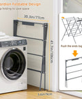 Heavy Duty Indoor Clothes Drying Rack With Twelve Solid Horizontal Rods And Tight Grip Sock Clips shown in accordion foldable design next to a washer.