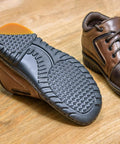 Bevel Design Rubber Heel Patch Kit For Shoes With Anti Slip Patches attached to a brown shoe, showing improved tread.