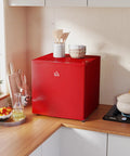 Score This Snazzy Countertop Mini Freezer For Easy Setup And Keep Your Daily Grub Ice Cold Using 1.1 Cubic Feet Of Removable Shelf Storage Built For Dorms Or Rv Life on kitchen counter with utensils.