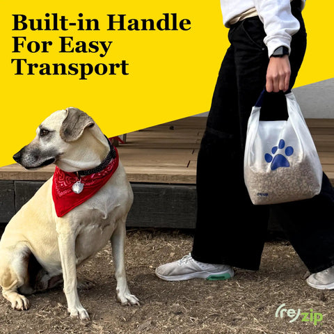 Person carrying Large Roll Top Pet Food Storage Bag With Airtight Seal Keeps Kibble Fresh 40 Cup Capacity BPA Free while dog sits nearby.