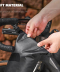 Hands securing a 5L Waterproof Bike Fork Bag For Mountain And Road Bikes Front Pannier Dry Bag with roll top closure on handlebars.
