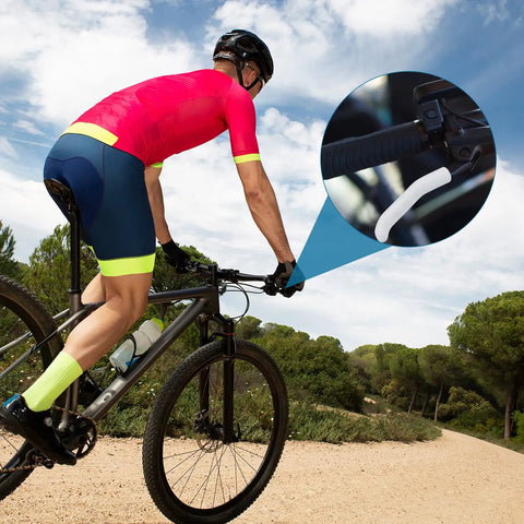 Cyclist riding with Bike Brake Lever Silicone Sleeve 2 Pack Anti Slip Cover For Mountain And Road Bikes on handlebars.