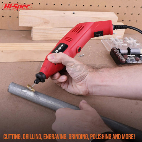 Person using Rock Solid 130W Corded Rotary Multi Tool Kit for cutting metal pipe with precision, red tool in action.