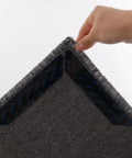 Close-up of hand lifting carpet showing Non Slip Rug Pads 12 Pack Gripper For Hardwood Floors Tile And Wood Under Rugs Carpet Tape