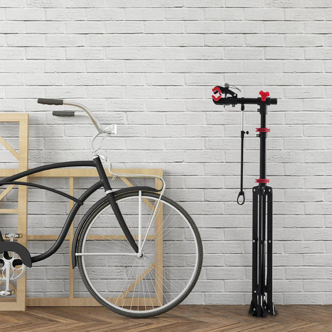 Bike Repair Stand Height Adjustable Work Station With 360 Degree Rotating Clamp And Quick Release Mechanism next to a bicycle