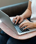 Person using laptop on MyStyle Lap Desk Pink Daisy 17 By 13.2 Inch Surface Fits 15.6 Inch Laptops Ultra Lightweight 1.15 Lb With Built In Carry Handle