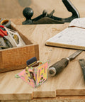 Heavy Duty 4 Pack Folding Table Leg Hinges With 90 Degree Self Locking Iron Brackets on a wooden workbench with tools