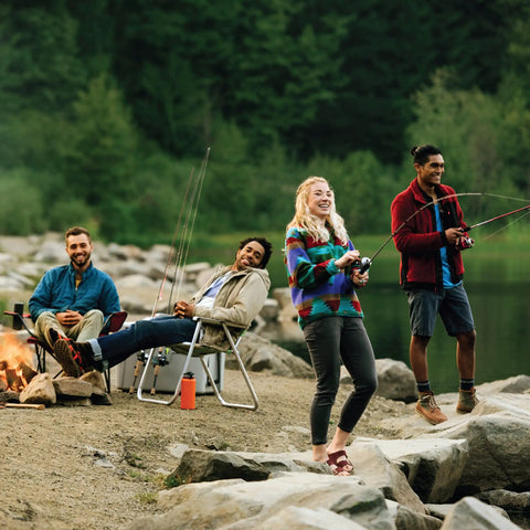 Friends fishing by a lake with Roam Spincast Reel And Fishing Rod Combo With A 6 Foot Fiberglass Rod ComfortGrip Handle outdoor