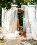 Outdoor patio setup with Four Panel Outdoor Mosquito Netting For Patio 118 W By 98 L No See Um Garden Mesh Curtains Sheer Tulle Netting.