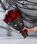 Spooky Spider Web Floral Wrapping Paper 18x18 Inches Black White Bouquet Wrap for Halloween Gifts held with red roses.