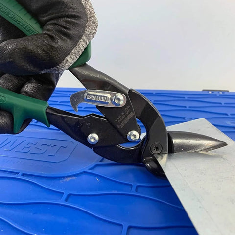 Midwest Blackout aviation tin snips, side view with green handle, cutting sheet metal.