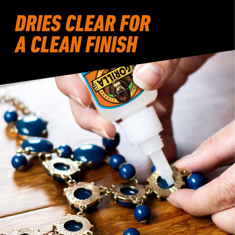 Person applying All Purpose Super Glue XL Clear Glue 25g Pack Of 2 For Fast Setting And Strong Bonds on a jewelry piece.