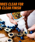 Hand applying Your Go To Clear Glue For All Purpose Bonding Fast On Glass Plastic Wood Metal Ceramic Rubber And More to necklace.