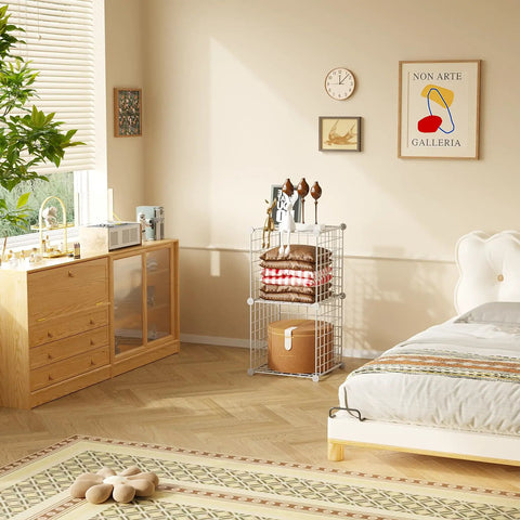 White wire cube storage organizer with 2 cubes metal grid shelving unit for home office, holding blankets and decor in a bedroom.