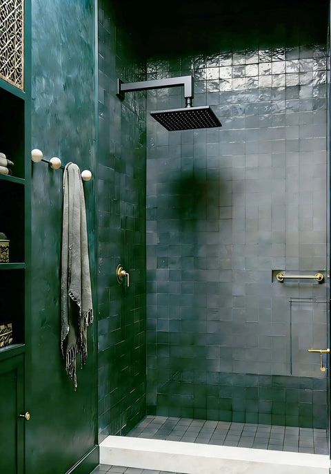 Matte black rain shower with 12-inch square solid brass arm, anti-scratch O-ring flange in modern green tiled bathroom.