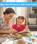 Mother and child using All In One Shrink Plastic Craft Kit For DIY Keychains And Shrink Art With 198 Pieces at a table